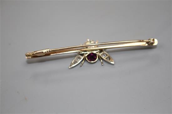 A Victorian 9ct, garnet and diamond set bug bar brooch, 54mm, gross weight 3.3 grams.
